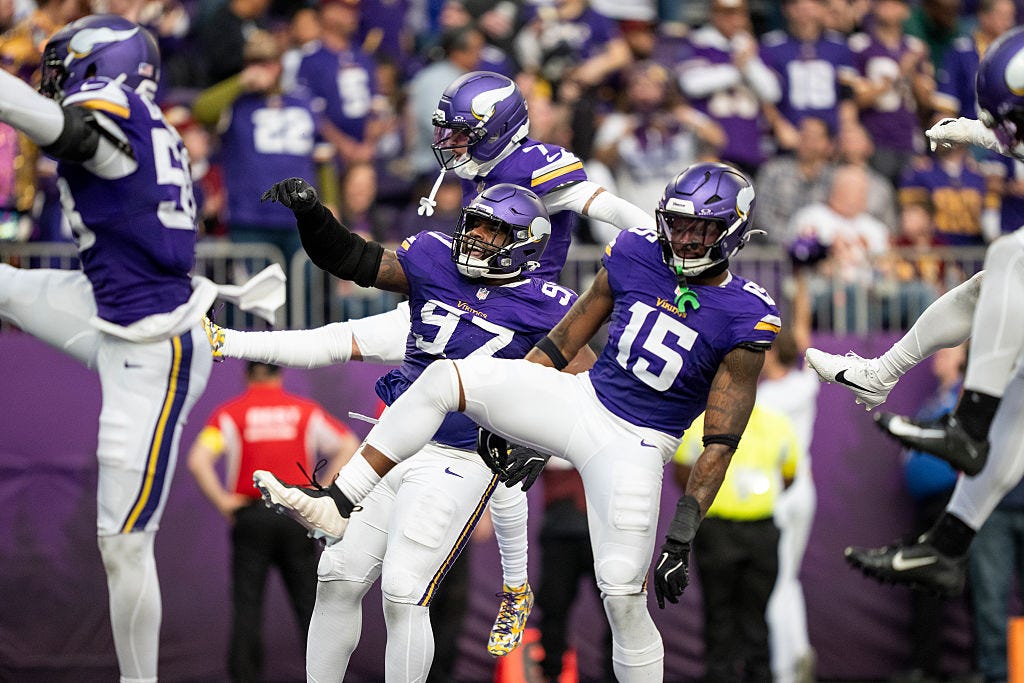 Dallas Turner and the Vikings defense celebrating a sack