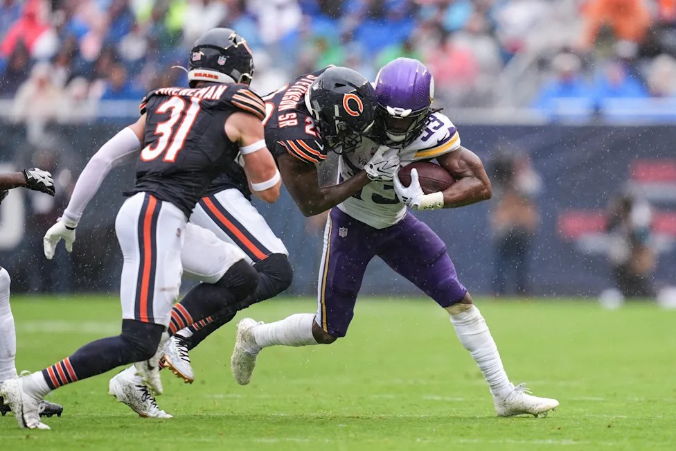 Aaron Jones stiff arming a Bears defender during the week two victory in Chicago